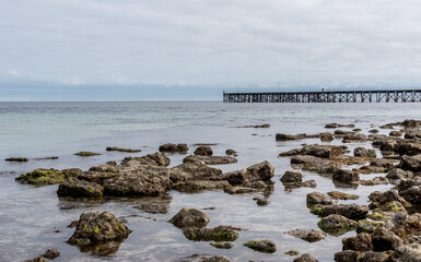 Rocks at the shoreline, beside an old wooden jetty on the Yorke Peninsula, South Australia