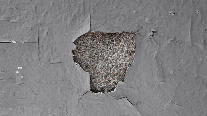 Closeup concrete color peeling off with hole grey paint on cement house distressed wall or ceiling texture background