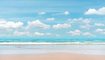 Fototapeta na wymiar Sand beach on blue sea, white wave under white clouds, pastel blue sky