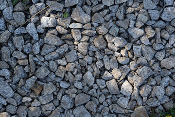 Real backround: grey crushed stones with sunbeam. 