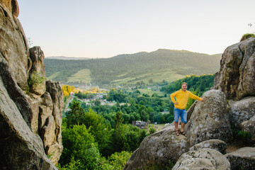A hiker in the mountains on the mountainside. Tustan, Ukraine.