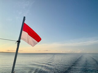 Indonesia flag over the sea. Nature background 