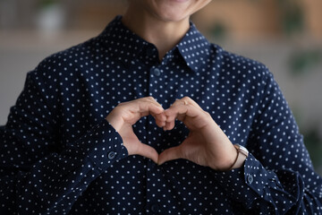 Crop close up of Indian woman show love heart hand gesture feel supportive grateful and thankful. Biracial female make sign demonstrate support and care, volunteer give help. Charity concept. - obrazy, fototapety, plakaty