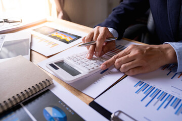 Close up woman hand using a calculator and writing make note, Tax Calculator And Pen, doing his accounting, financial adviser working,  managing budget, finance and investment, accounting