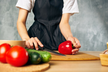 housewife on the kitchen cutting vegetables