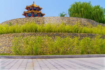 Slate pavement, stone walls and green bamboo background, sunny weather, park summer