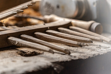 Close-up of old rakes in a rustic work shop