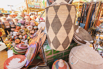 A large pile of various wicker hand made baskets for sale on the local African market. Traditional...