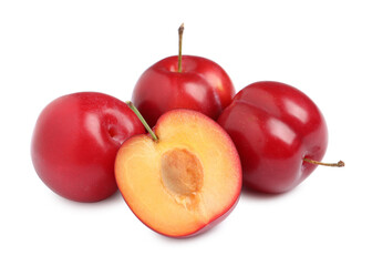 Cut and whole cherry plums on white background