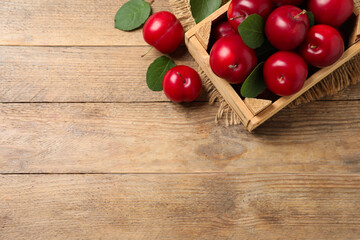 Fresh ripe cherry plums on wooden table, flat lay. Space for text