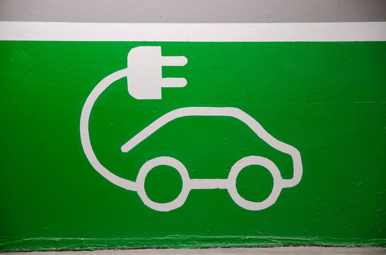 Roadsign of free electric car charging station in a European supermarket parking lot. 