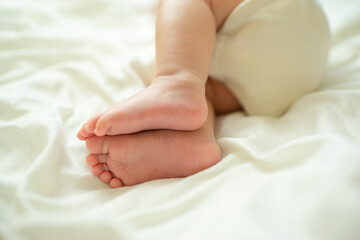 close up newborn feet on white blanket