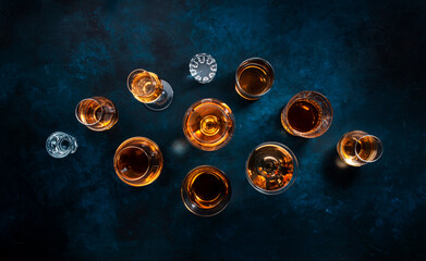 Strong alcohol drinks, hard liquors, spirits and distillates iset in glasses: cognac, scotch,...