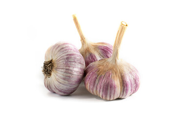 Three fresh heads of garlic on a white background.