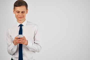 business man in a shirt with a tie with a phone in his hands communication