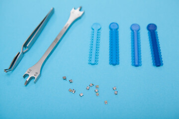 Dental instruments and blue elastics for braces