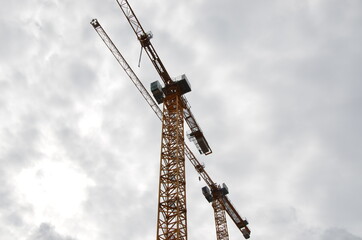 yellow tower cranes on huge construction site