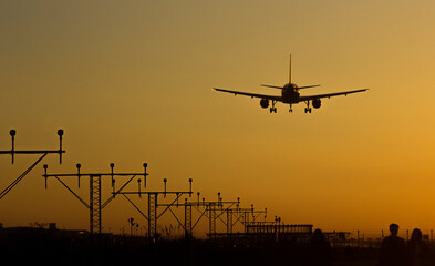 Fototapeta na wymiar Plane landing on the runway 25R at Barcelona airport; Barcelona, Spain