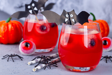 Spooky Halloween cocktail with red bubble drink and eyes made from lychee and blueberry