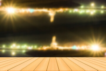 Empty wood table top and blur of night park .For montage product display
