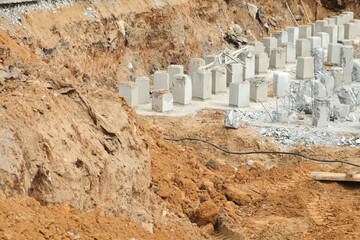 The beginning of the construction of the building in the pit. Installing piles in ground, work in...