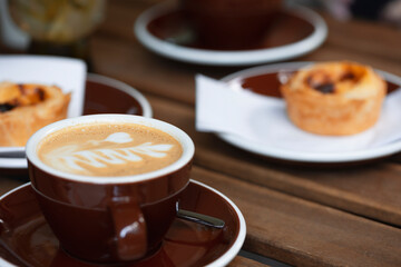 a cup of coffee and Pasteis