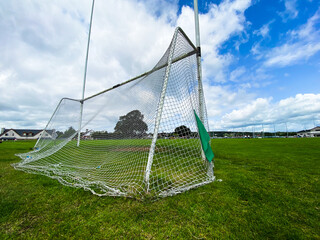 Fototapeta A Gaelic games goal on a summer cloudy day with nobody on the pitch obraz