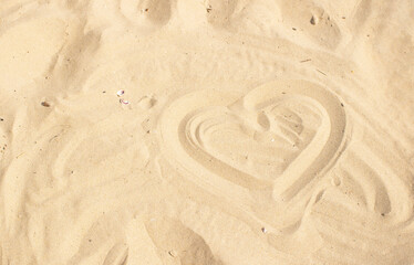Heart drawn in the sand. On the seaside. Summer and love.