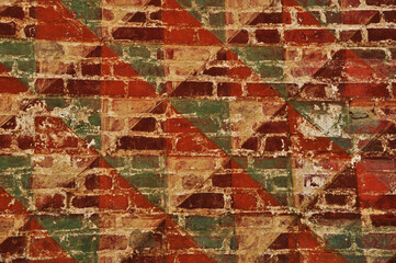 Old brick wall. The old walls are painted in different colors.
