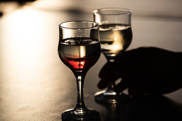 Glass of red wine in the sunset.