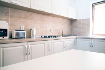 Cozy bright kitchen interior with wooden furniture