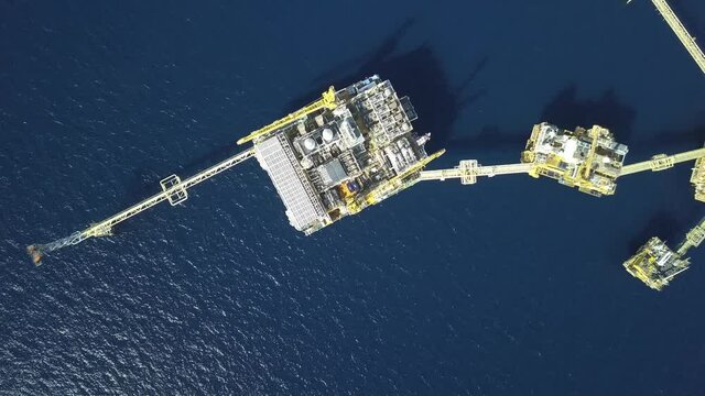 Central processing platform (cpp) in the middle of the ocean on sunny day - upstream industry

