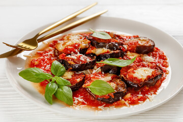 eggplant parmigiana on a white plate, top view