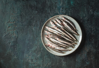 Anchovies top view copy space dark background.