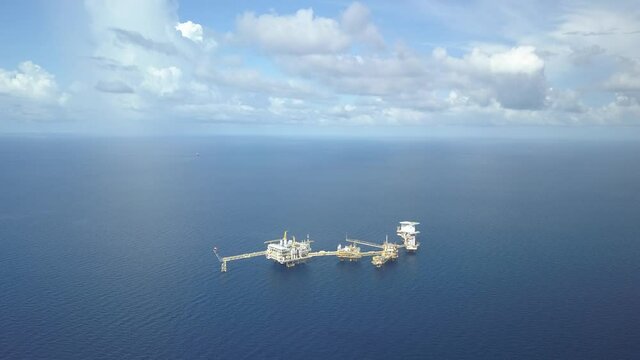 Central processing platform (cpp) in the middle of the ocean on sunny day - upstream industry
