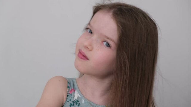 little cute girl combing her hair and drying it