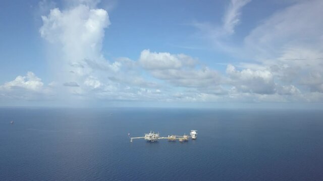 Central processing platform (cpp) in the middle of the ocean on sunny day - upstream industry

