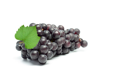 Fresh black seedless grapes with leaf isolated on white background.