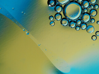 Closeup of oil drops motion on water surface. Colorful abstract macro background of oil drops on...