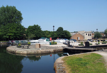 scenic view of brighouse basin with boats and moorings and the lock gates to the calder and hebble navigation canal in west yorkshire