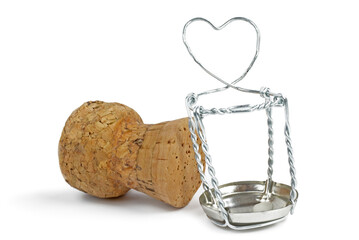 Champagne cork and wire cage with symbolical heart isolated on white background. Selective focus.