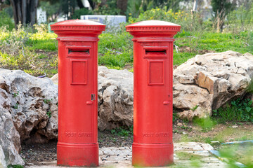 Fototapeta na wymiar Red mailboxes, Israel. Two old mailboxes on the street of Jerusalem.