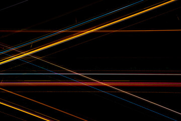 colored lines of light on a black background.textura