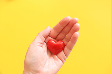 Fototapeta premium Woman holding heart symbol of love