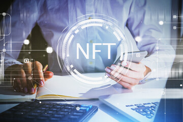 Woman hands with laptop and smartphone, non-fungible token hologram, nft with network circuit and globe. Concept of cryptocurrency art and technology