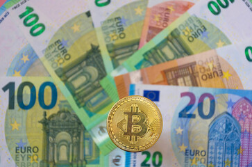 The new virtual money Bitcoin BTC crypto gold coin and Euro currency, selective focus