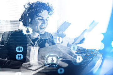 Businessman is typing message on computer and listening to podcast
