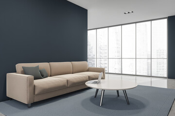 Minimalist blue and grey living room space with beige couch. Corner view.