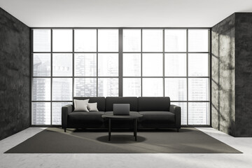 Dark living room interior with large comfortable black sofa