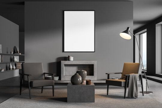 Poster in dark grey living room with two armchairs and fireplace